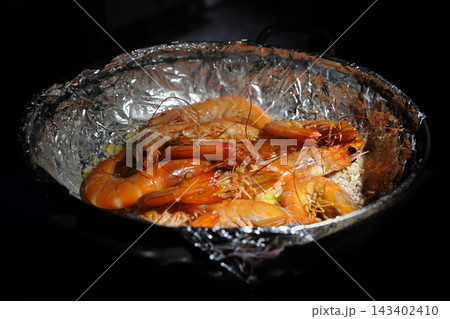 Delicious grilled prawns or shrimps on salt, cooked to bright orange colo 143402410