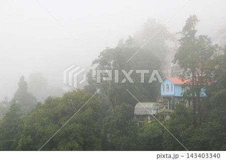 Blue house and forest on a rainy day in Darjeeling, India. Blue house and forest on a rainy day in Darjeeling, India. 143403340