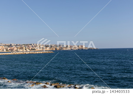 Syracuse skyline along sunlit Mediterranean seaside promenade Syracuse skyline along sunlit Mediterranean seaside promenade 143403533