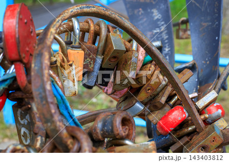 Rusty Metal Love Padlocks Locked on Bridge Railing for Eternal Relationship Concept 143403812