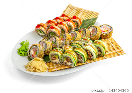 Big sushi set with tempura rolls, cucumber wrapped rolls and rolls with red tobiko on bamboo mat, isolated on white background Big sushi set with tempura rolls, cucumber wrapped rolls and rolls with red tobiko on bamboo mat, isolated on white background 143404560