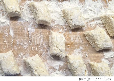 Homemade Gnocchi Dough on a Floured Wooden Surface for Italian Cooking Homemade Gnocchi Dough on a Floured Wooden Surface for Italian Cooking 143404985