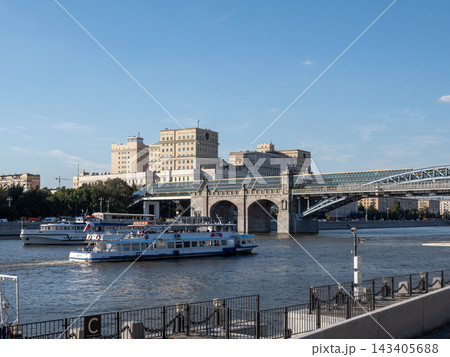 10 August 2026 Russia Moscow riverboat sailing along the Moskva River with the historic Ministry of Defense building on Frunzenskaya Embankment in the background 143405688