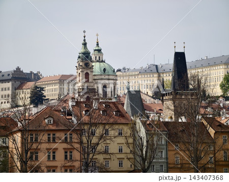 Bustling urban environment characterized by religious architecture and diverse rooftop arrangements Bustling urban environment characterized by religious architecture and diverse rooftop arrangements 143407368