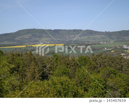Scenic landscape with colorful patches. Peaceful countryside featuring patchwork patches and distant hills Scenic landscape with colorful patches. Peaceful countryside featuring patchwork patches and distant hills 143407659