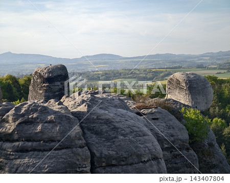 Expansive rocky landscape with view. Sprawling stonetopped expanse with distant fields and hills Expansive rocky landscape with view. Sprawling stonetopped expanse with distant fields and hills 143407804