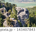 Majestic twin cliffs. Tall twin rock formations with moss and layered textures stand prominently 143407843