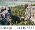 Secluded canyon with towering cliffs. Remote forested gorge featuring steep vertical rocks and shaded areas 143407844