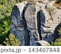 Detailed cliff texture. Sandstone face with lichen shadows. Weathered rock facade with moss and cracks 143407848