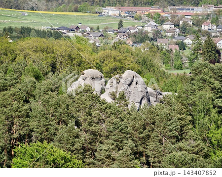 Ancient rocks amid lush forest. Mosscovered boulders and cliffs peering through forest canopy 143407852