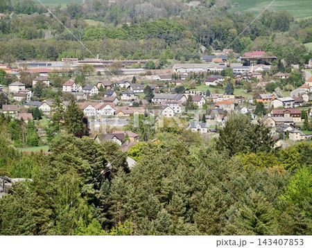 Urban scene with buildings and trees. Residential landscape showcasing rooftops and surrounding streets Urban scene with buildings and trees. Residential landscape showcasing rooftops and surrounding streets 143407853