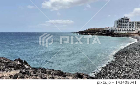 A Beautiful Serene Coastal View Featuring a Hotel and a Rocky Shoreline for Everyone to Enjoy 143408041
