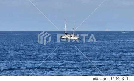 Sailing calmly on the serene and tranquil ocean A stunning and beautiful yacht is in full view Sailing calmly on the serene and tranquil ocean A stunning and beautiful yacht is in full view 143408130