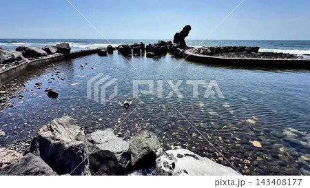 Tranquil and Serene Seascape Featuring a Beautiful Rock Formation with Crystal Clear Water 143408177