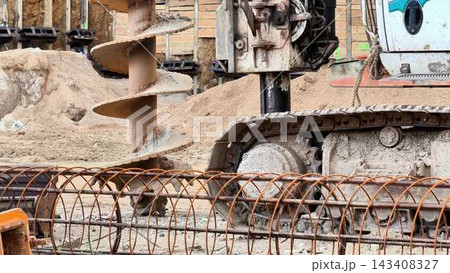 Heavy Machinery Utilized in Construction Projects Featuring the Versatile Auger Drill Heavy Machinery Utilized in Construction Projects Featuring the Versatile Auger Drill 143408327