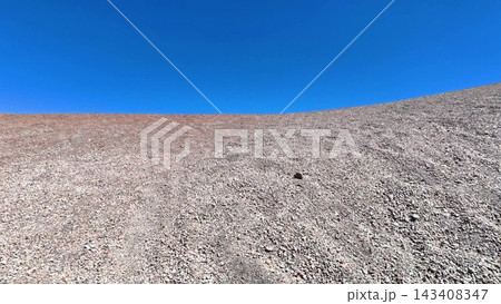 A Barren Landscape Set Against a Clear Blue Sky, Depicting a Serene Wilderness Scene A Barren Landscape Set Against a Clear Blue Sky, Depicting a Serene Wilderness Scene 143408347