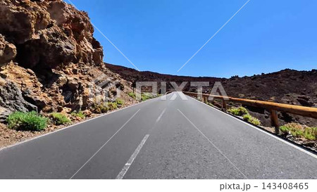 Experience the breathtaking scenic road winding through a stunning volcanic landscape 143408465