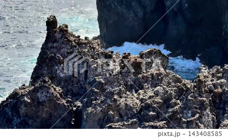 Experience the breathtaking majestic coastal rock formation with powerful crashing waves 143408585