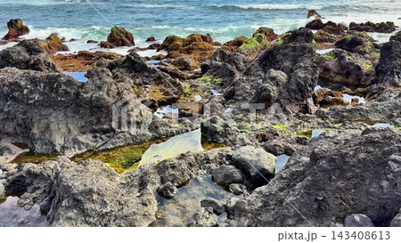 A beautiful Rocky Coastal Landscape featuring Tide Pools alongside Ocean Waves gently crashing A beautiful Rocky Coastal Landscape featuring Tide Pools alongside Ocean Waves gently crashing 143408613