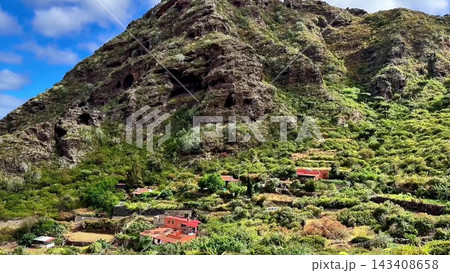 The breathtaking view of a mountain landscape featuring terraced fields complemented by a cloudy sky The breathtaking view of a mountain landscape featuring terraced fields complemented by a cloudy sky 143408658