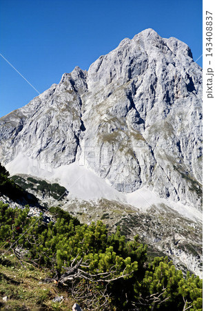 Majestic Sonnenspitze Mountain Peak with Lush Greenery Below, Austria Majestic Sonnenspitze Mountain Peak with Lush Greenery Below, Austria 143408837