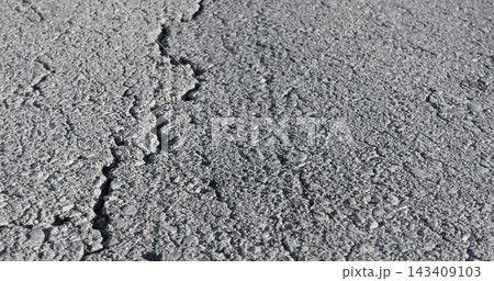 Cracked asphalt road surface Cracked asphalt road surface 143409103