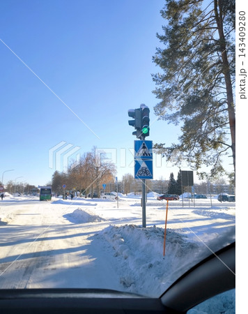 Traffic light showing green on a snow-covered city street. Joensuu, Finland Traffic light showing green on a snow-covered city street. Joensuu, Finland 143409280
