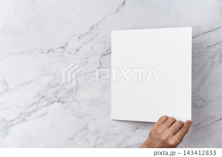 Top view sequence from open to close blank white greeting card mockup on marble background with copy space : hand opening a blank white folded greeting card Top view sequence from open to close blank white greeting card mockup on marble background with copy space : hand opening a blank white folded greeting card 143412833