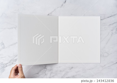 Top view sequence from open to close blank white greeting card mockup on marble background with copy space : hand opening a blank white folded greeting card Top view sequence from open to close blank white greeting card mockup on marble background with copy space : hand opening a blank white folded greeting card 143412836