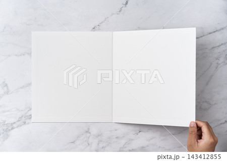 Top view sequence from open to close blank white greeting card mockup on marble background with copy space : hand closing a blank white folded greeting card Top view sequence from open to close blank white greeting card mockup on marble background with copy space : hand closing a blank white folded greeting card 143412855