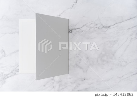 Top view sequence from open to close blank white greeting card mockup on marble background with copy space : closing a blank white folded greeting card 143412862