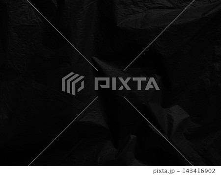 Black background plastic wrinkle bag film glossy crumpled overlay package rough wrap material pack reflection texture floor packaging retail grain pollution trash polyethylene, halloween backdrop. 143416902