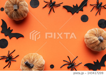 Halloween decor with pumpkins, spiders, bats on orange background Halloween decor with pumpkins, spiders, bats on orange background 143417209