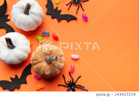Halloween pumpkins bats spiders and candy corn on orange background Halloween pumpkins bats spiders and candy corn on orange background 143417219