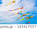 Flying colorful kites in the blue sky. Kite Festival. Concept of freedom and summer leisure 143417557