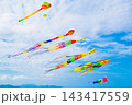 Flying colorful kites in the blue sky. Kite Festival in summer 143417559