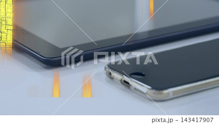 Resting smartphone in clear case showing home button on glossy desk, tablet reflections, copy space 143417907