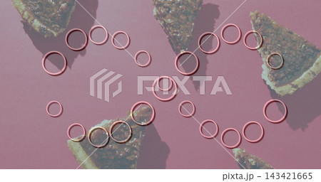 Glistening metallic-pink rings forming interlocking loops on dusty-pink mat, nut-filled pie slices Glistening metallic-pink rings forming interlocking loops on dusty-pink mat, nut-filled pie slices 143421665