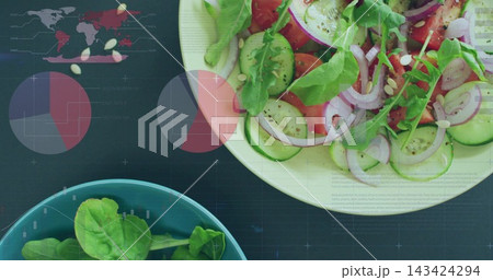 Displaying large white salad bowl sitting on dark tabletop, with teal bowl and infographic overlays 143424294