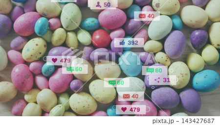 Covering dense cluster of pastel speckled candy eggs on light wood tabletop, showing social badges Covering dense cluster of pastel speckled candy eggs on light wood tabletop, showing social badges 143427687