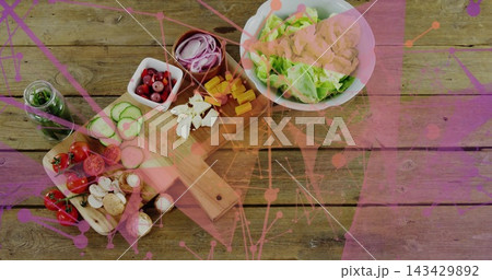 Displaying wooden board and white bowl showing salad ingredients on wood tabletop, magenta overlay Displaying wooden board and white bowl showing salad ingredients on wood tabletop, magenta overlay 143429892