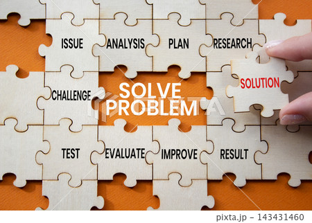 Solve problem symbol. Concept words solve problem on wooden puzzle pieces. Businessman hand. Beautiful orange background. Problem solving concept. Copy space. Solve problem symbol. Concept words solve problem on wooden puzzle pieces. Businessman hand. Beautiful orange background. Problem solving concept. Copy space. 143431460