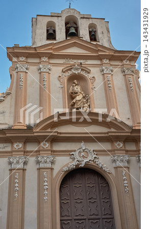 Facade of a historic church with a wooden door and sculpture in Monreale, Sicily, Italy Facade of a historic church with a wooden door and sculpture in Monreale, Sicily, Italy 143431929
