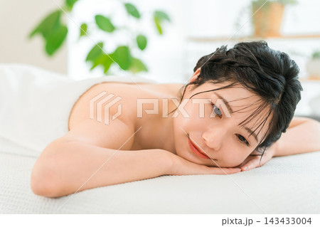 エステサロンのベッドでうつ伏せになりリラックスする若い女性 143433004