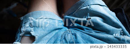 Ripped blue denim fabric clothing fashion banner 143433335