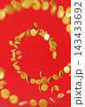 Coins are arranged in a spiral pattern against a red background, creating a finance theme. This design offers space for additional text or branding 143433692