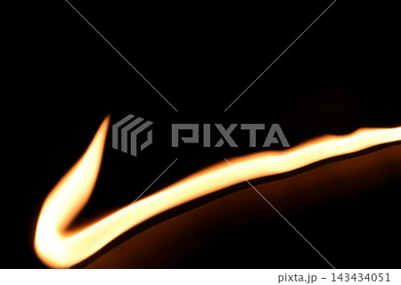 An abstract glowing golden or amber line on a dark background. 143434051
