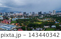 Dramatic skyline view of Kuala Lumpur with lush green park below 143440342