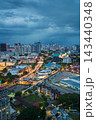 Evening cityscape of Kuala Lumpur with vibrant lights and dramatic sky 143440348