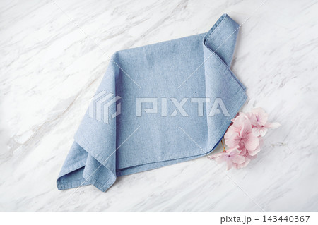 Blue linen tablecloth on white marble kitchen table texture background, top view Blue linen tablecloth on white marble kitchen table texture background, top view 143440367
